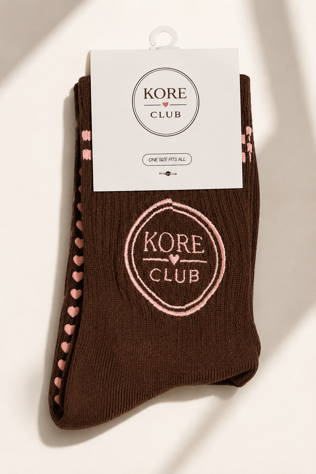 Kore Club Mid-Rise Grip Sock in packaging, embroidered logo